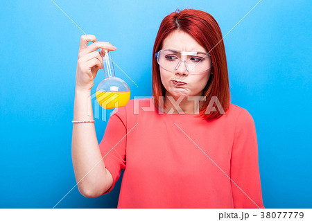 Redhair nerd with a flask of yellow liquid in her Redhair nerd with a flask of yellow liquid in her 38077779