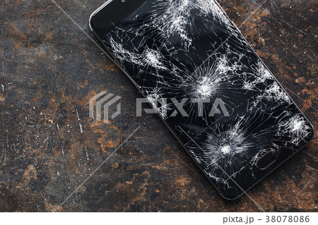 Big modern smartphone with broken screen debris Big modern smartphone with broken screen debris 38078086