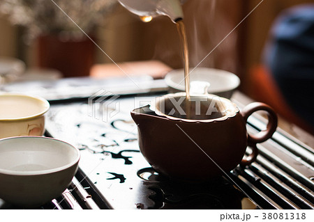 Pouring of Puer Tea from Teapot at Traditional Pouring of Puer Tea from Teapot at Traditional 38081318