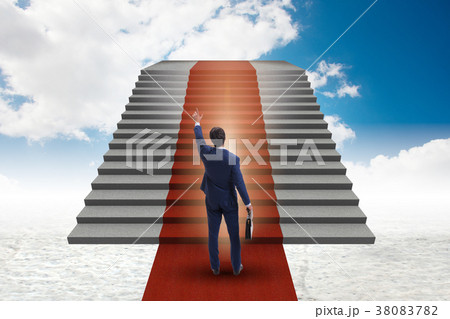 Young businessman climbing stairs and red carpet 38083782