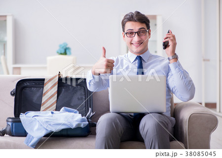 Businessman preparing packing for business trip 38085045