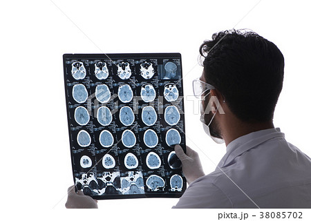 Young doctor looking at x-ray images isolated on 38085702