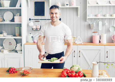 Portrait of handsome smiling man at kitchen Portrait of handsome smiling man at kitchen 38088989
