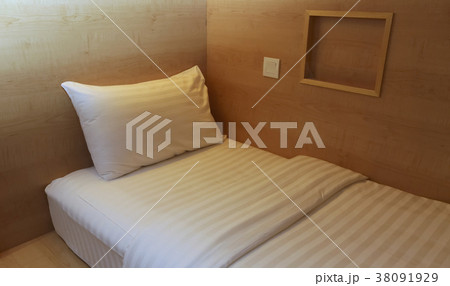 Bed in small simple hotel bedroom Bed in small simple hotel bedroom 38091929