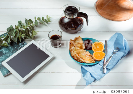 The tablet and pancakes with juice. Healthy The tablet and pancakes with juice. Healthy 38097062
