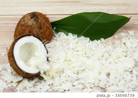 Coconut cut in half and coconut flakes around 38098739