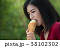 Asian women are eating mud ice cream. 38102302