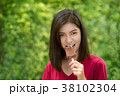 Asian women are eating chocolate ice cream. 38102304