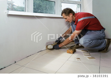 Laying the tiles Laying the tiles 38103391