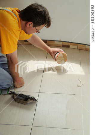 Fill the tile joints with grout Fill the tile joints with grout 38103392