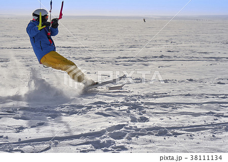 A male athlete engaged in snow kiting A male athlete engaged in snow kiting 38111134