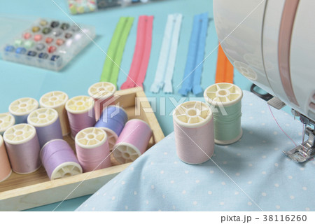 Fabrics on sewing machine amid the accessories 38116260