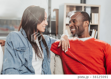 Smiling enamored man and woman sitting together 38125091