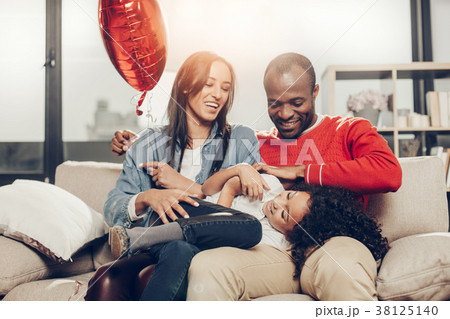 Glad family spending time together inside 38125140