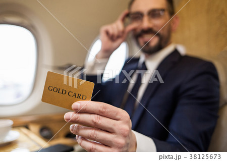 Blissful mature male showing his card 38125673