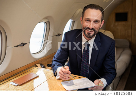 Glad solid man doing his paperwork 38125683