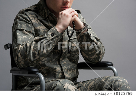 Handicapped military young male praying Handicapped military young male praying 38125769