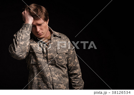 Unhappy male veteran remembering past 38126534