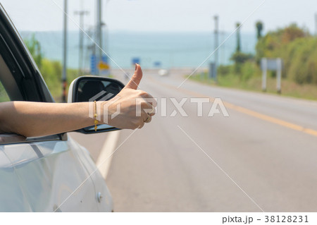 travel hand thumbs In the car on the road 38128231