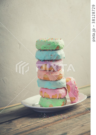 A stack of donuts on wooden table A stack of donuts on wooden table 38128729