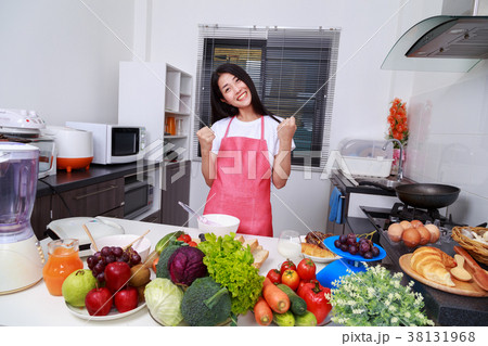 happy woman cooking in kitchen room 38131968