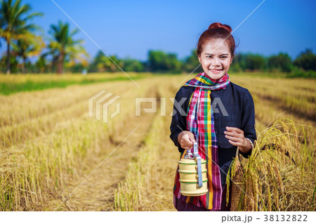 farmer woman with tiffin carrier in rice field 38132822
