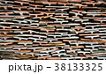 Tiles of different shades are stacked in pile. 38133325