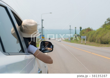 Woman on the road with a Sea and beach Woman on the road with a Sea and beach 38135287