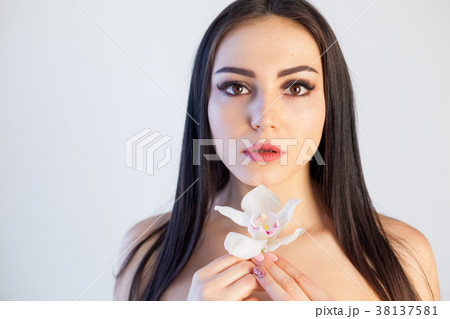 Portrait of a girl with a flower Orchid Spa skin Portrait of a girl with a flower Orchid Spa skin 38137581