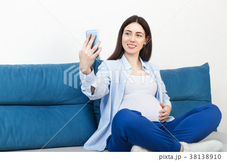 pregnant woman taking selfie pregnant woman taking selfie 38138910