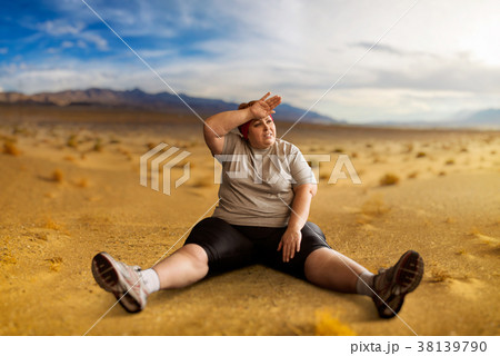 Overweight woman sitting in desert valley 38139790