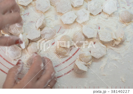 hands taking homemade potstickers. Motion blur. 38140227
