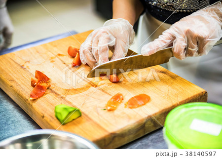 Hands in gloves cut vegetables Hands in gloves cut vegetables 38140597