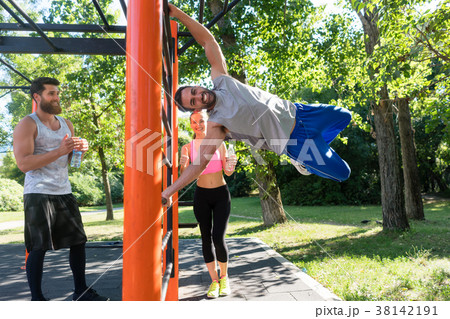Strong young man practicing human flag exercise 38142191