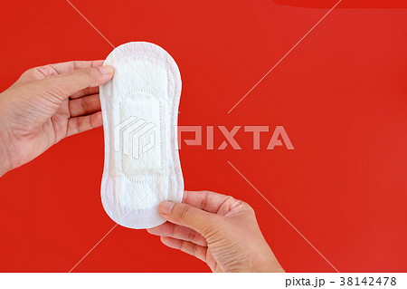 Hand holding feminine sanitary napkin Hand holding feminine sanitary napkin 38142478