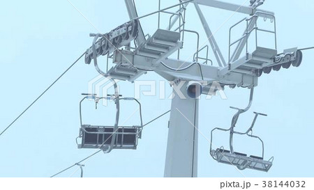 Operating ski chairlift in the fog 38144032
