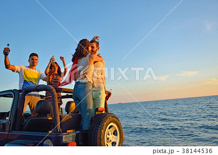 Group of happy friends making party in car - Young Group of happy friends making party in car - Young 38144536
