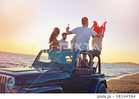 Group of happy friends making party in car - Young 38144564