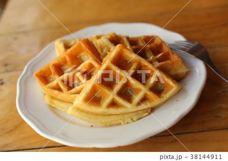 plain waffles served on plate for breakfast close up top photo 38144911