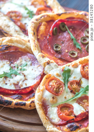 Mini pizzas on the wooden board Mini pizzas on the wooden board 38145280