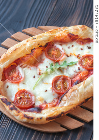 Mini pizza on the wooden board Mini pizza on the wooden board 38145281