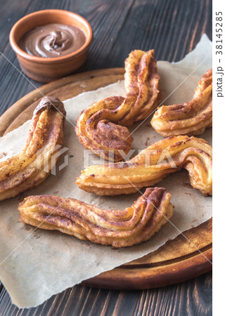 Churros with chocolate sauce Churros with chocolate sauce 38145285