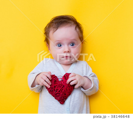 little baby with red heart shape toy 38146648