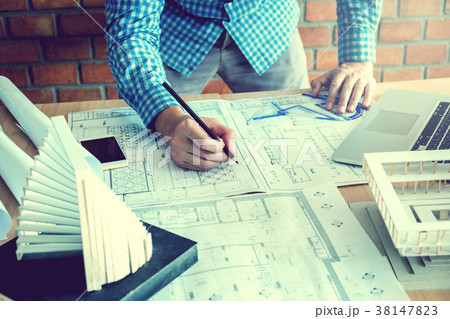 Architect or engineer working in office blueprint 38147823