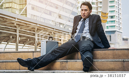 Desperate businessman sitting hopelessly on stair floor Desperate businessman sitting hopelessly on stair floor 38151037