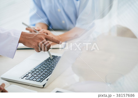 Doctor pointing at computer screen Doctor pointing at computer screen 38157686