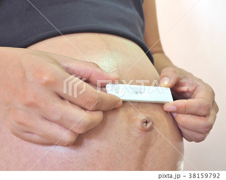 pregnant woman holding  Pregnancy test. 38159792