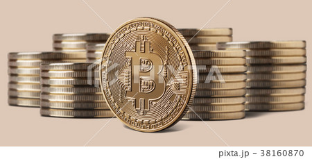Single bitcoin coin standing in front of stacks of Single bitcoin coin standing in front of stacks of 38160870