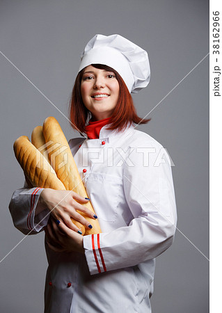 Photo of woman cook in white robe and cap with 38162966