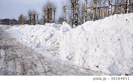 Snow cleaning in winter in the city. Large piles Snow cleaning in winter in the city. Large piles 38164651